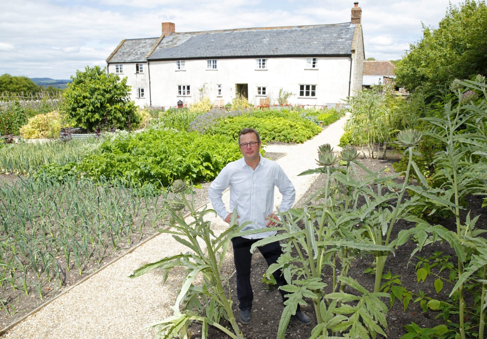 Hugh Fearnley-Whittingstall standing in garden