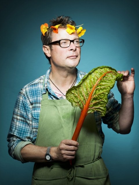 Hugh Fearnley-Whittingstall wearing flower crown and holding kale