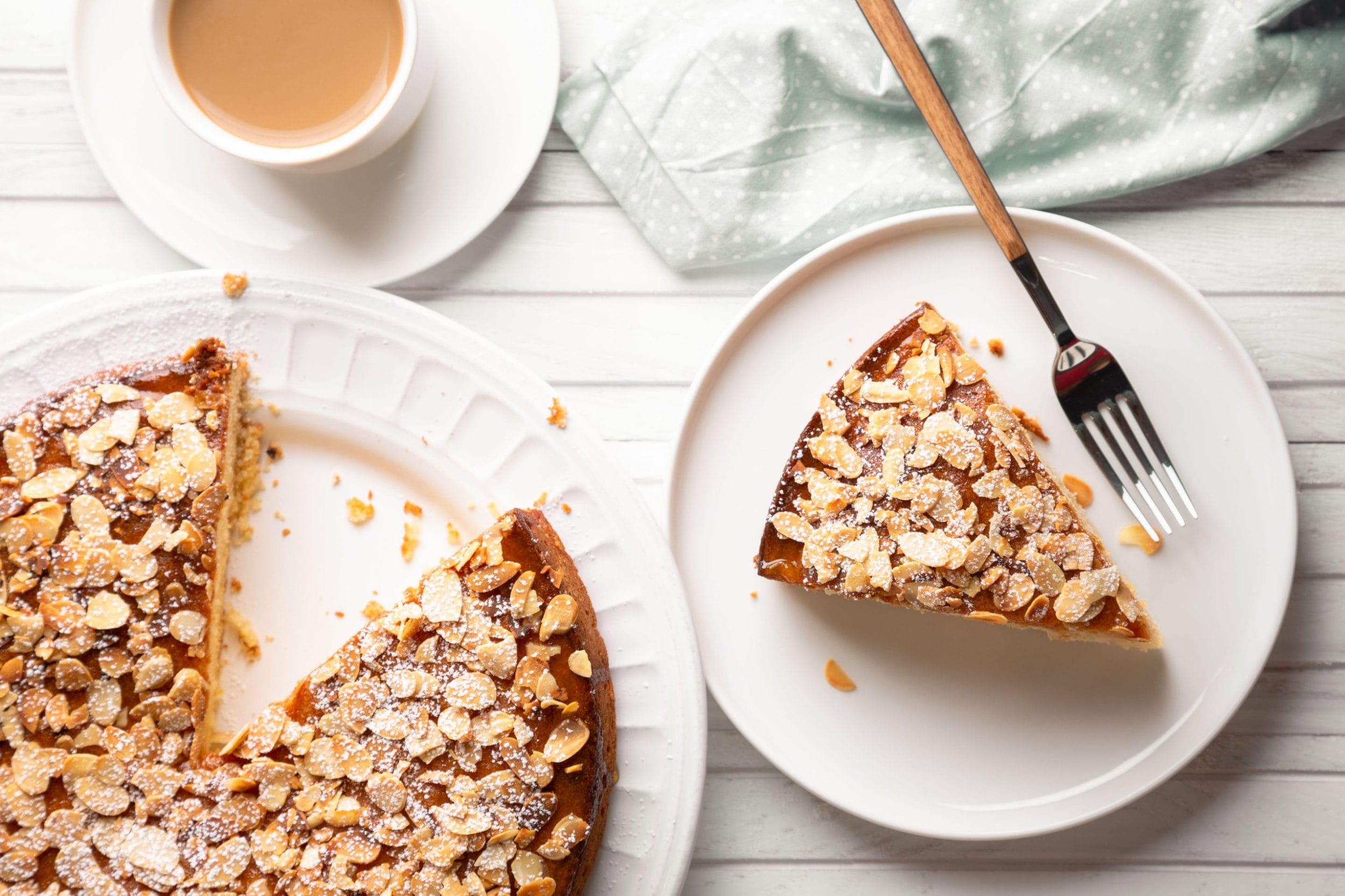 Seedy almond cake on a white table and white plates