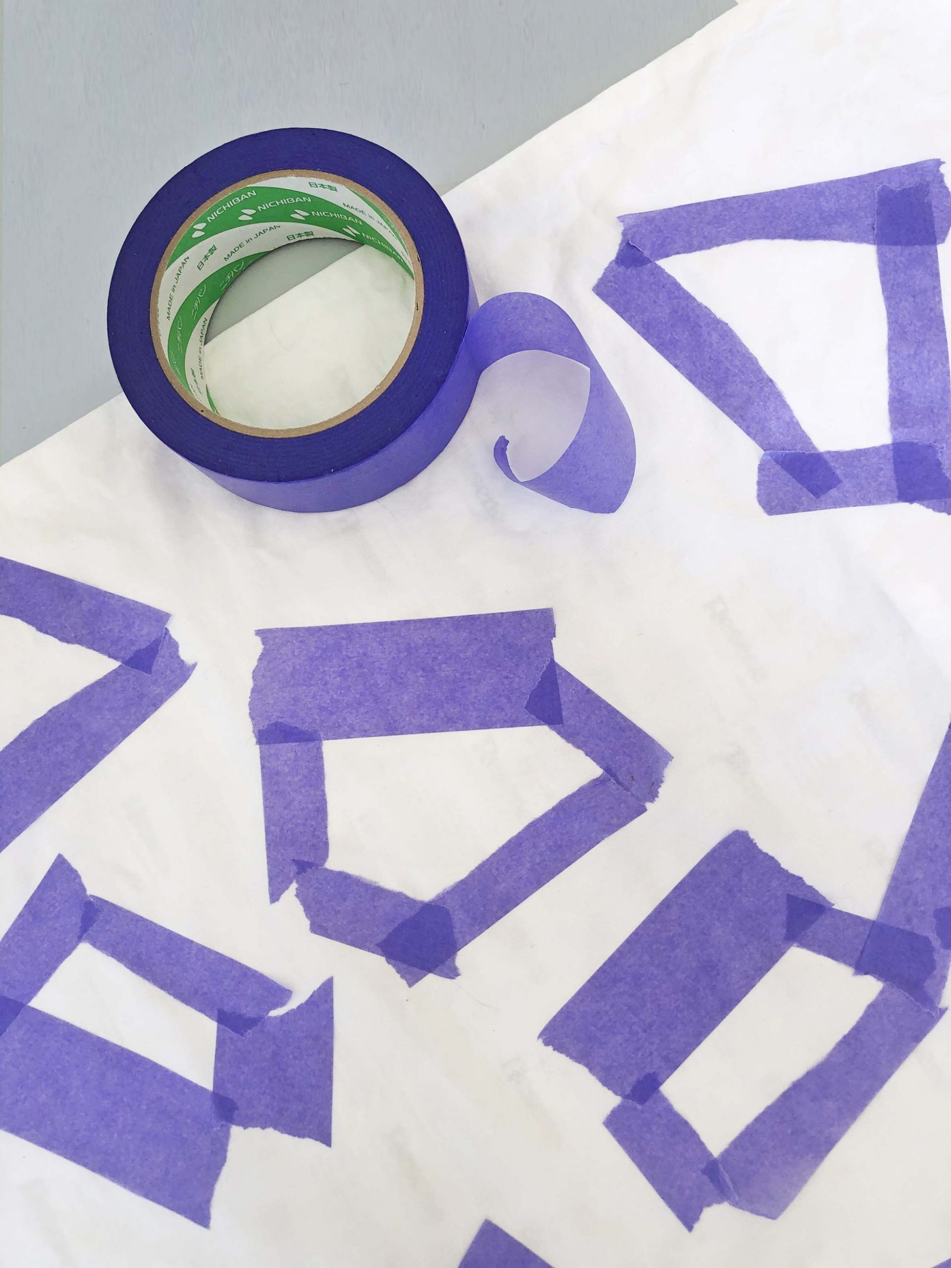 A white pillowcase with purple tape on it 