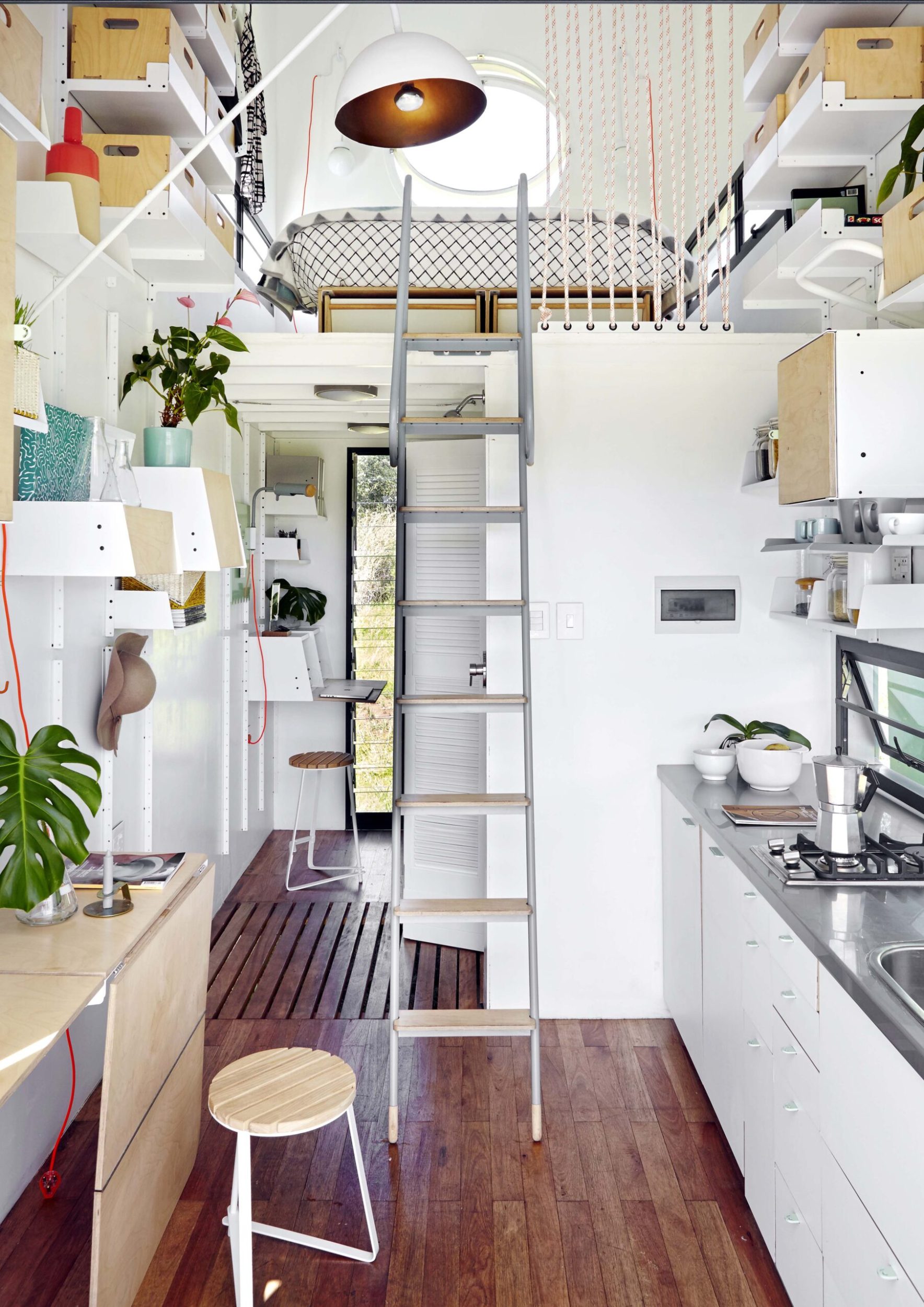 Interior of a small home with a ladder to second story