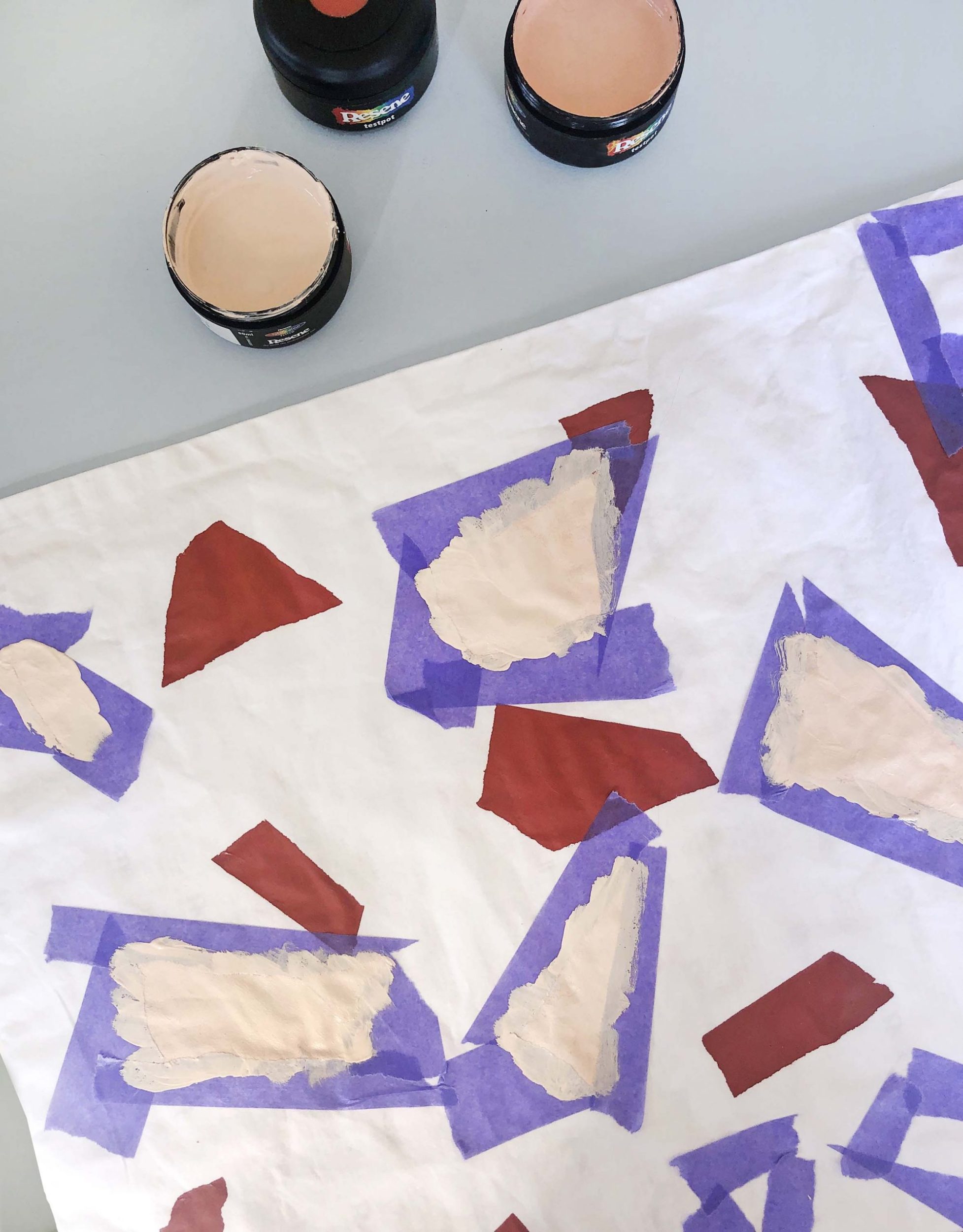 A white pillowcase with red and beige colours shapes on it 