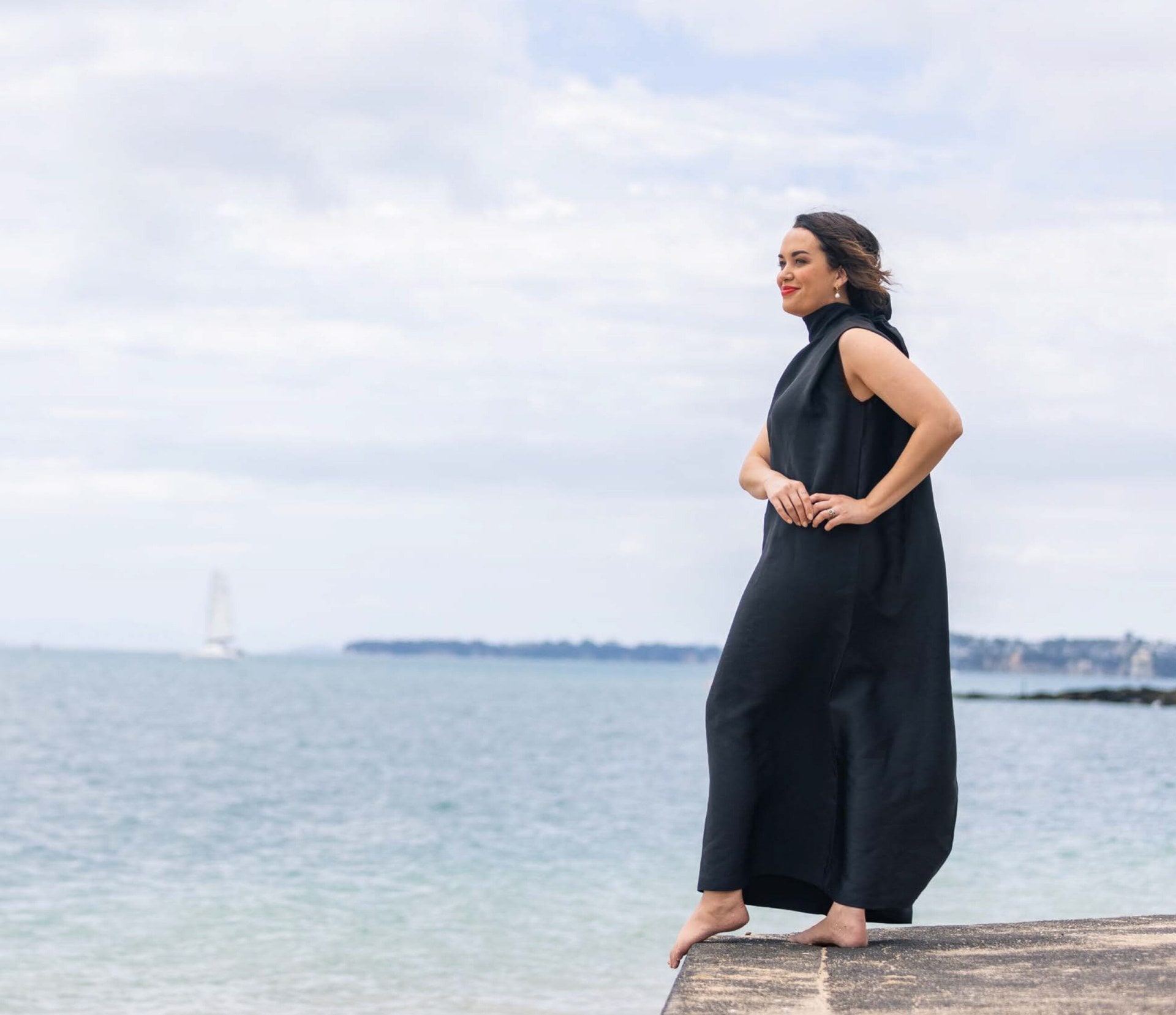 Kanoa Lloyd stands on dock wearing black dress