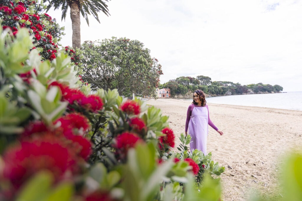 Kanoa Lloyd wearing lilac dress walking on beach