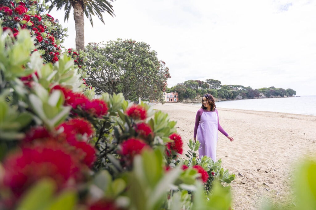 Kanoa Lloyd wearing lilac dress walking on beach 