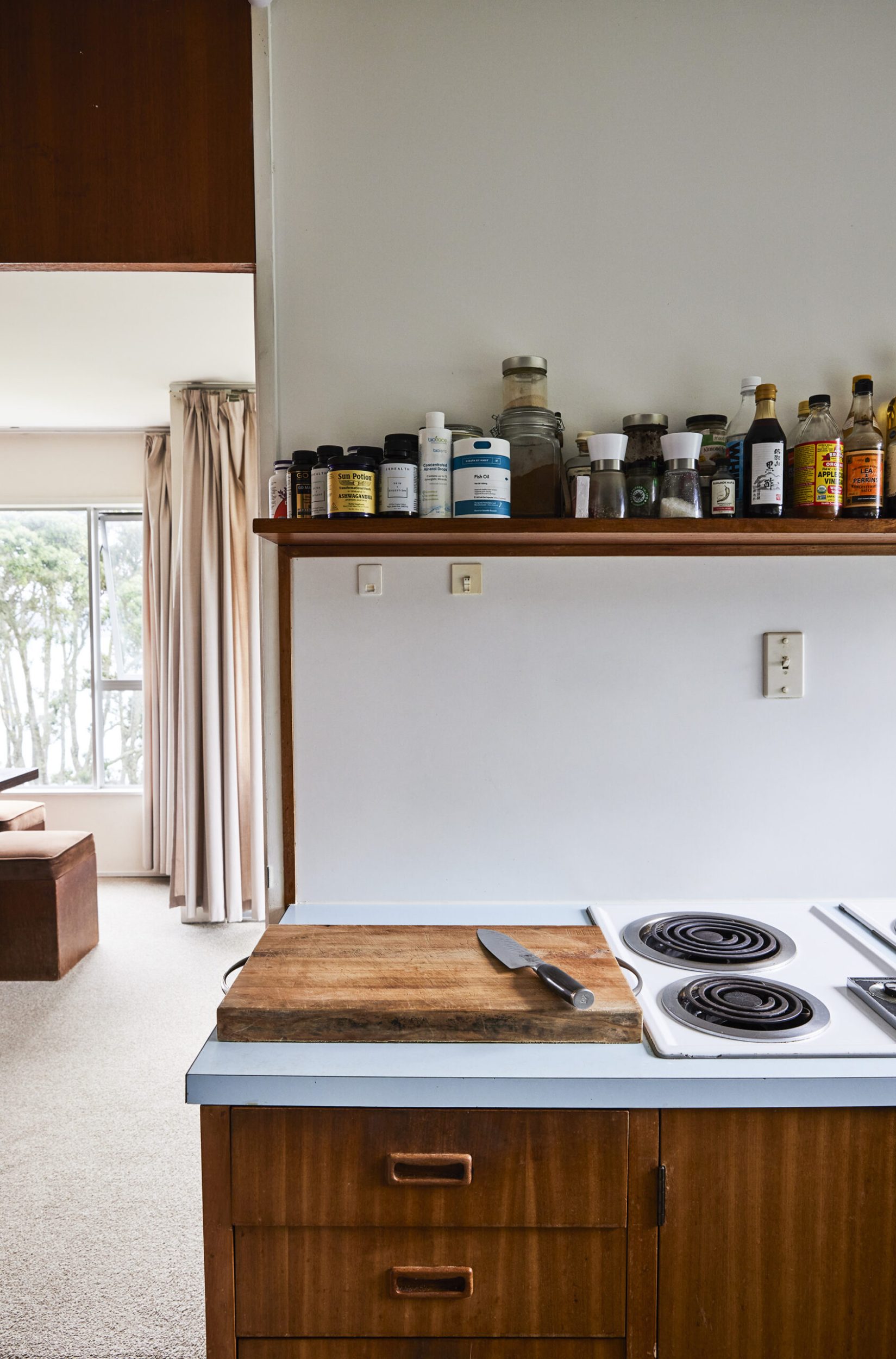 A mid-century kitchen with dark wood panels