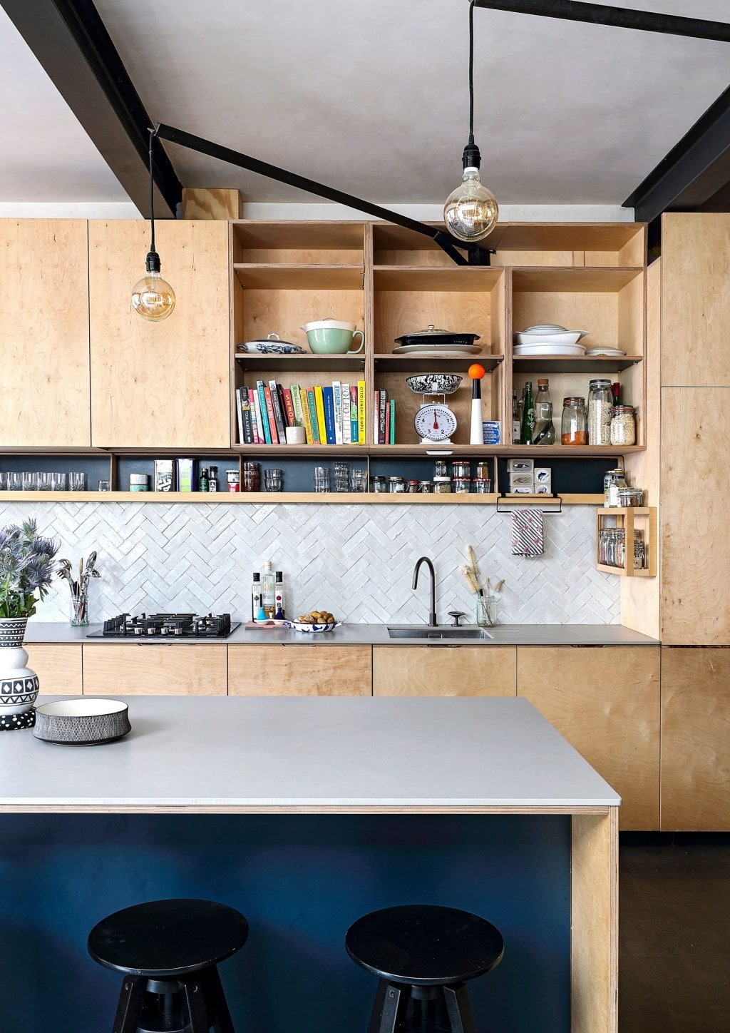 Kitchen with grey tiles and benchtops and wooden shelves