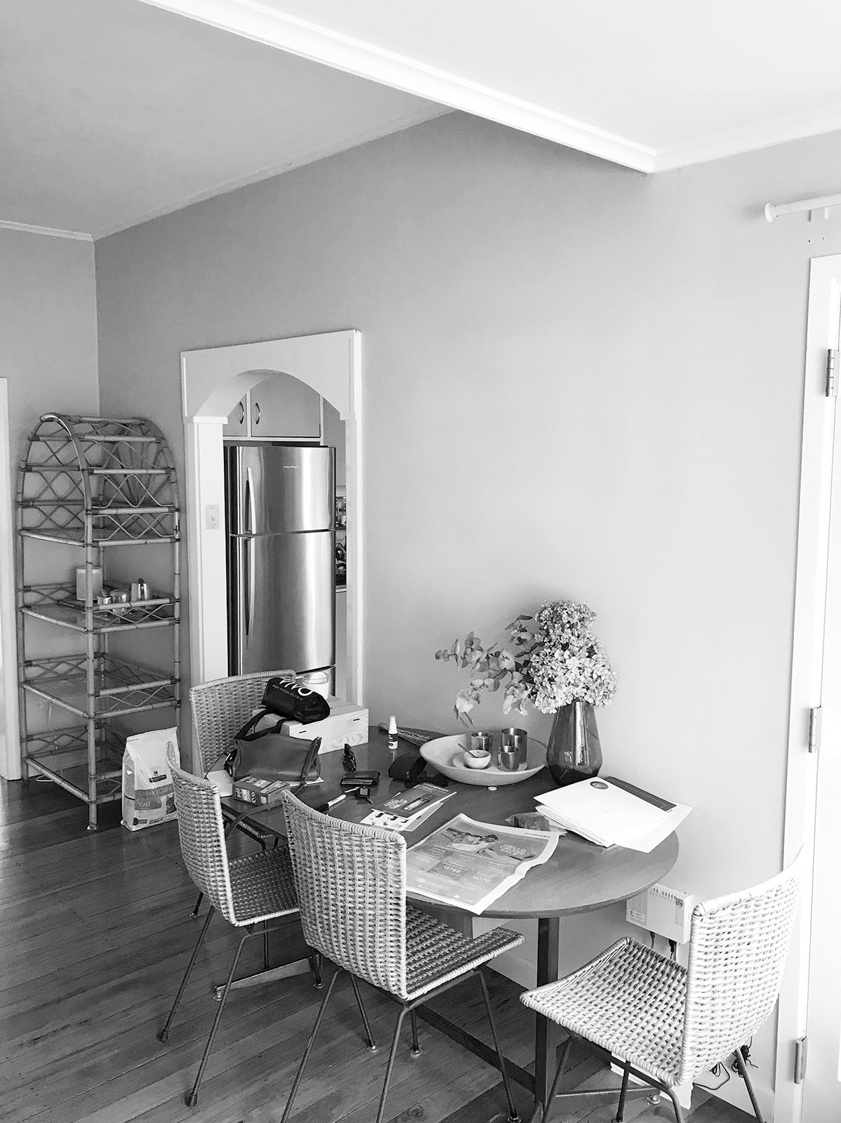 A black and white photo of a small dining area