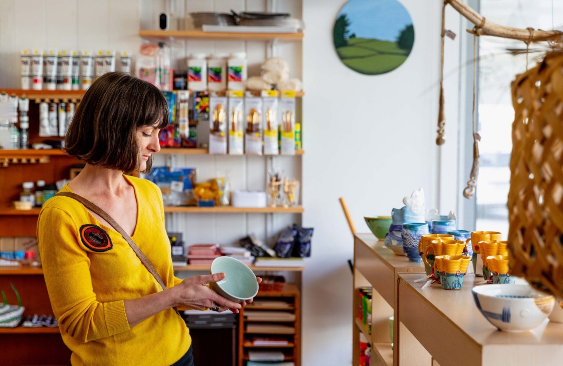 Octavia Cook holding a green caramic bowl at Pea Sea Art