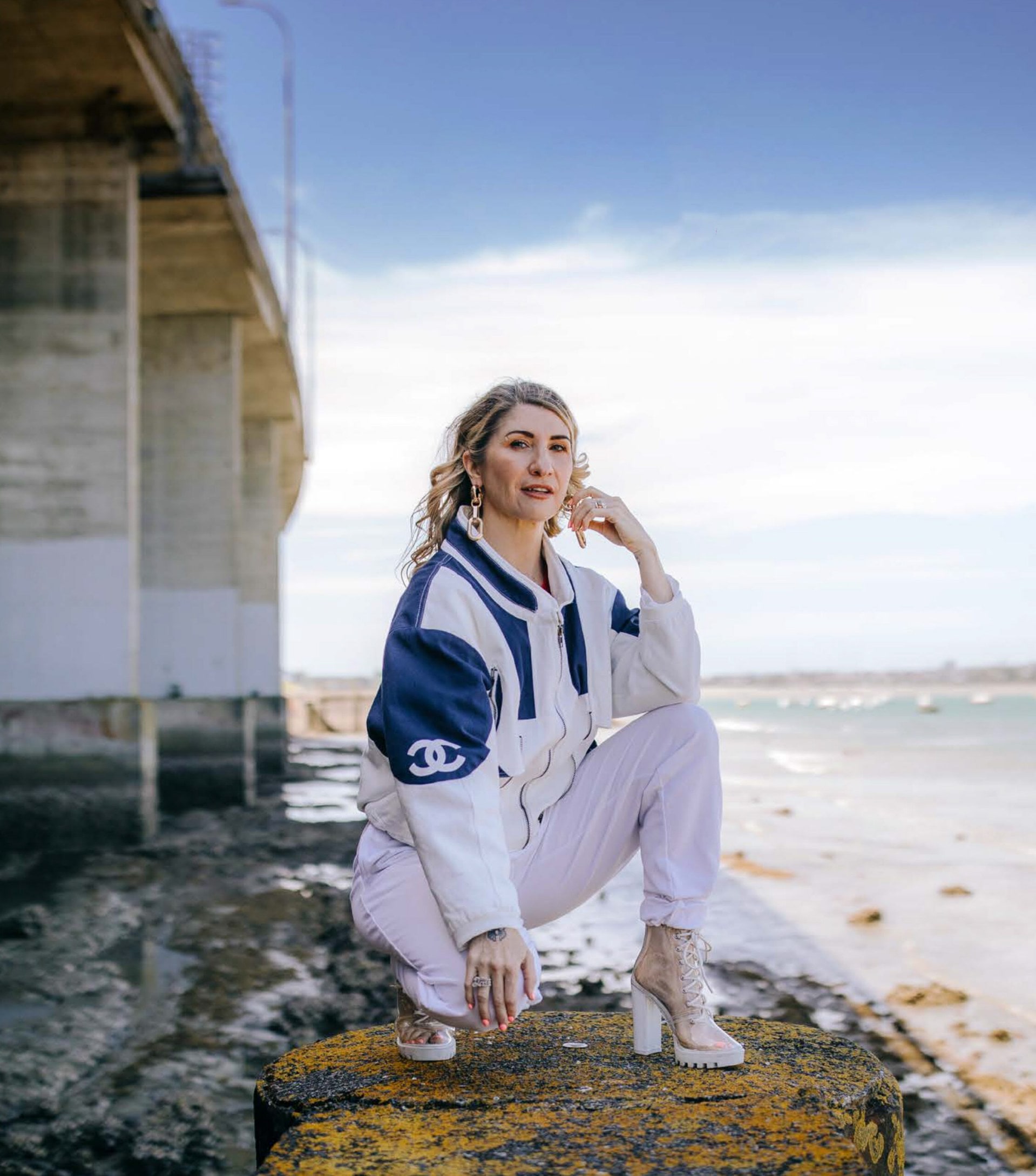 MC Tali wearing tracksuit by the ocean 
