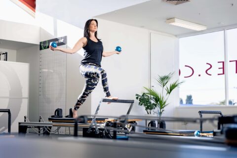 Claire Chitham in a reformer pilates studio