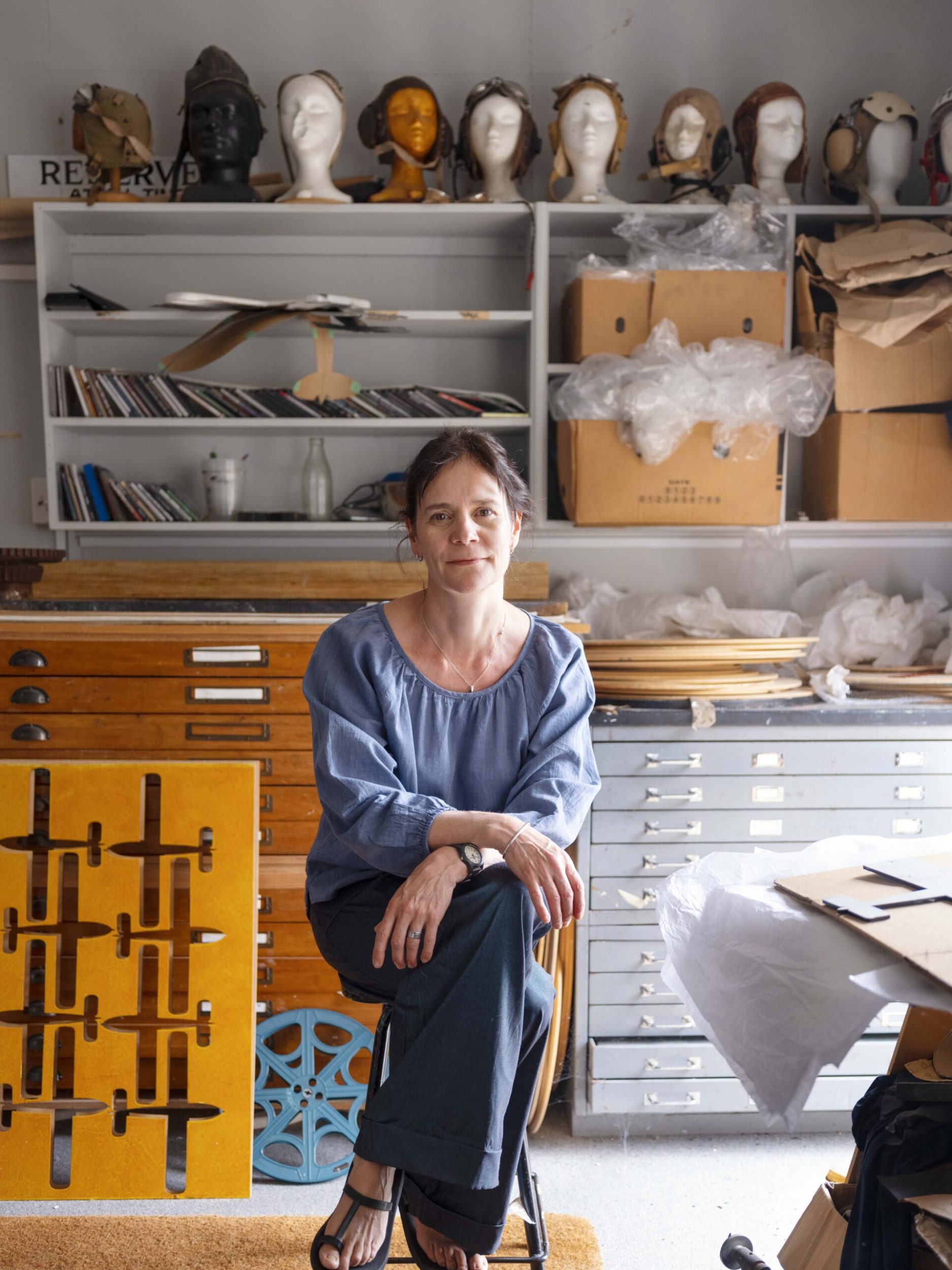 Artist Michele Bryant sitting in her workshop