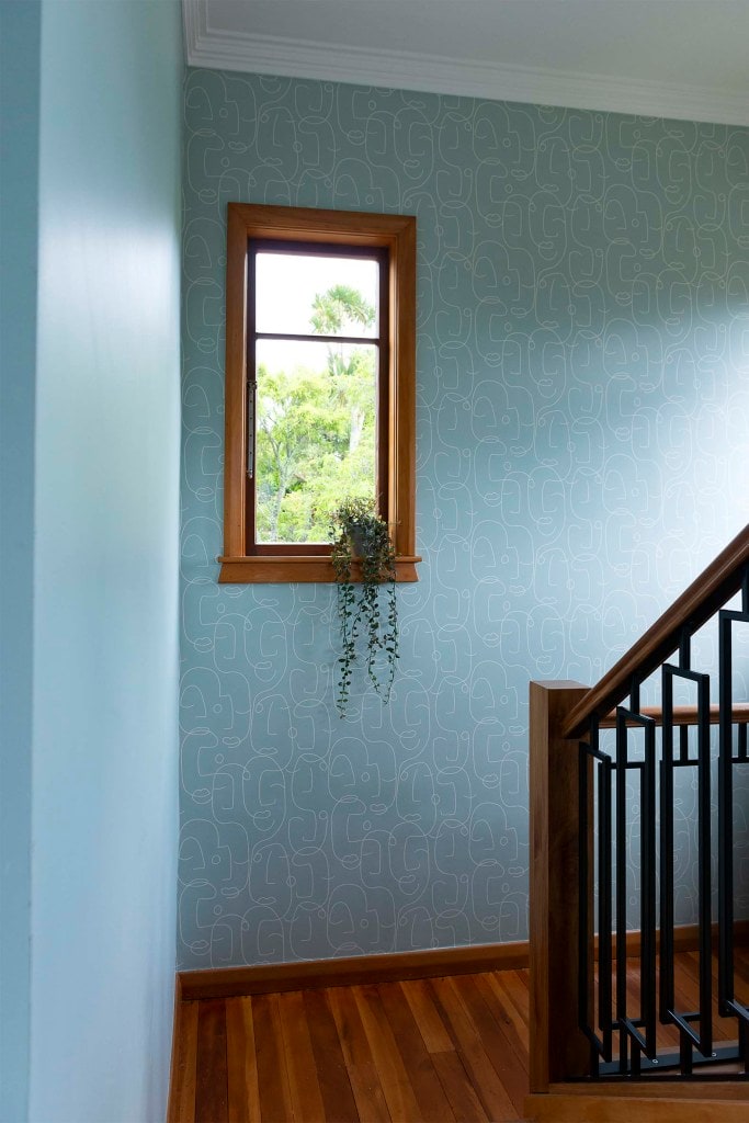 Staircase landing with blue line pattern wallpaper