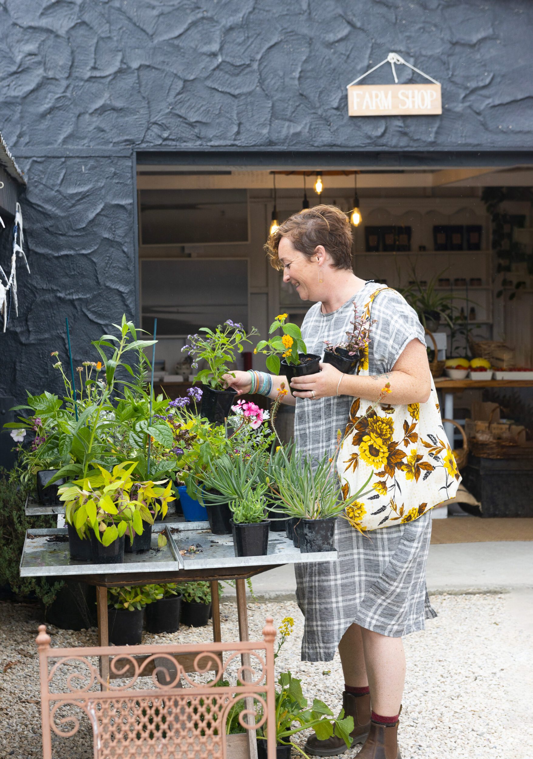 Fleur Woods at a market picking up green potted plants