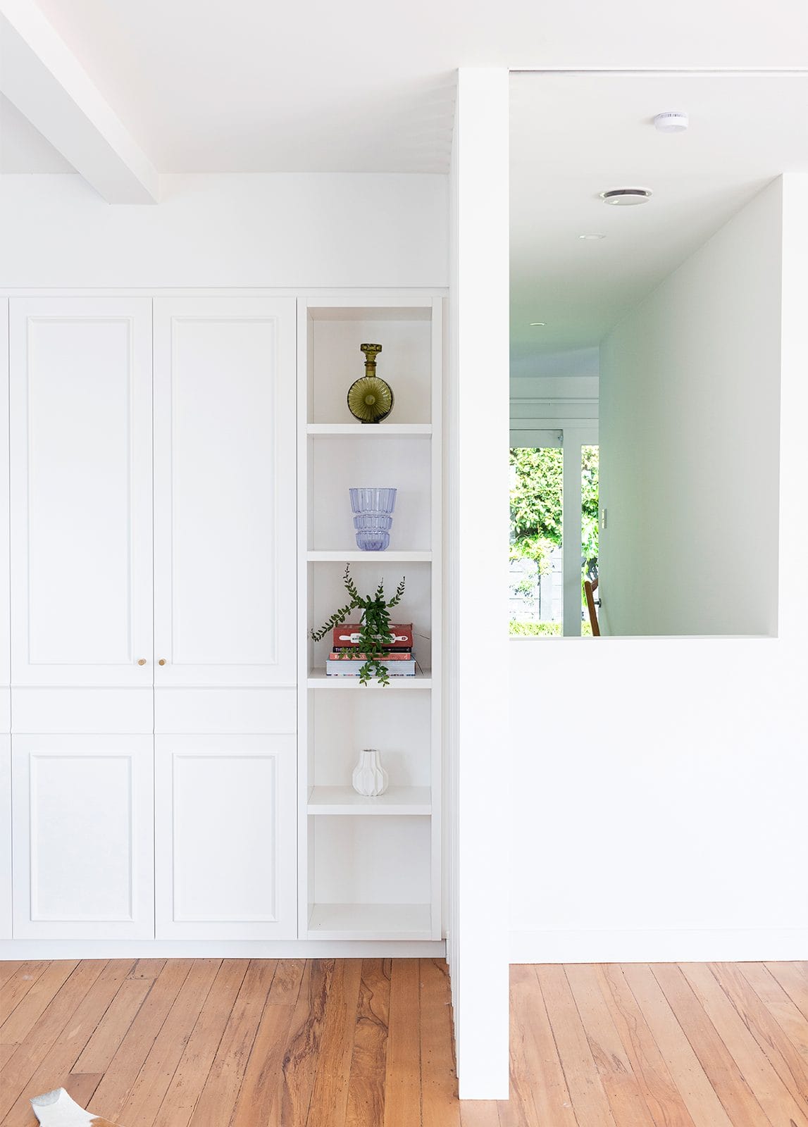 White inbuilt shelving and cupboard