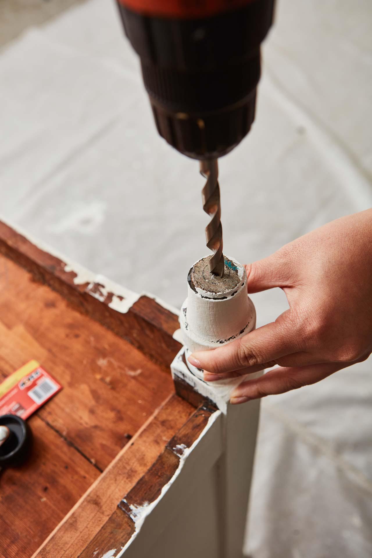 Drilling hole in chest of drawers foot