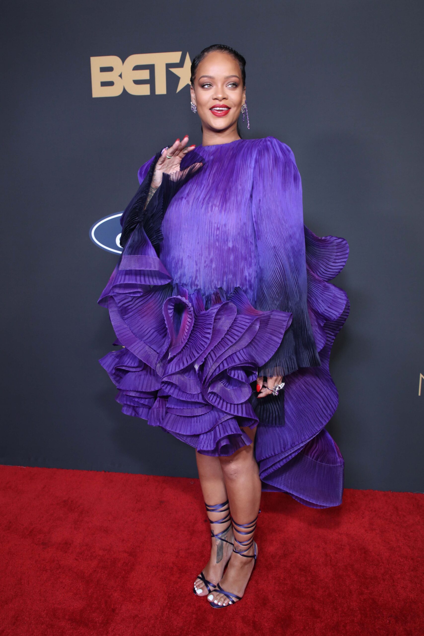 Rihanna on the red carpet wearing a purple dress