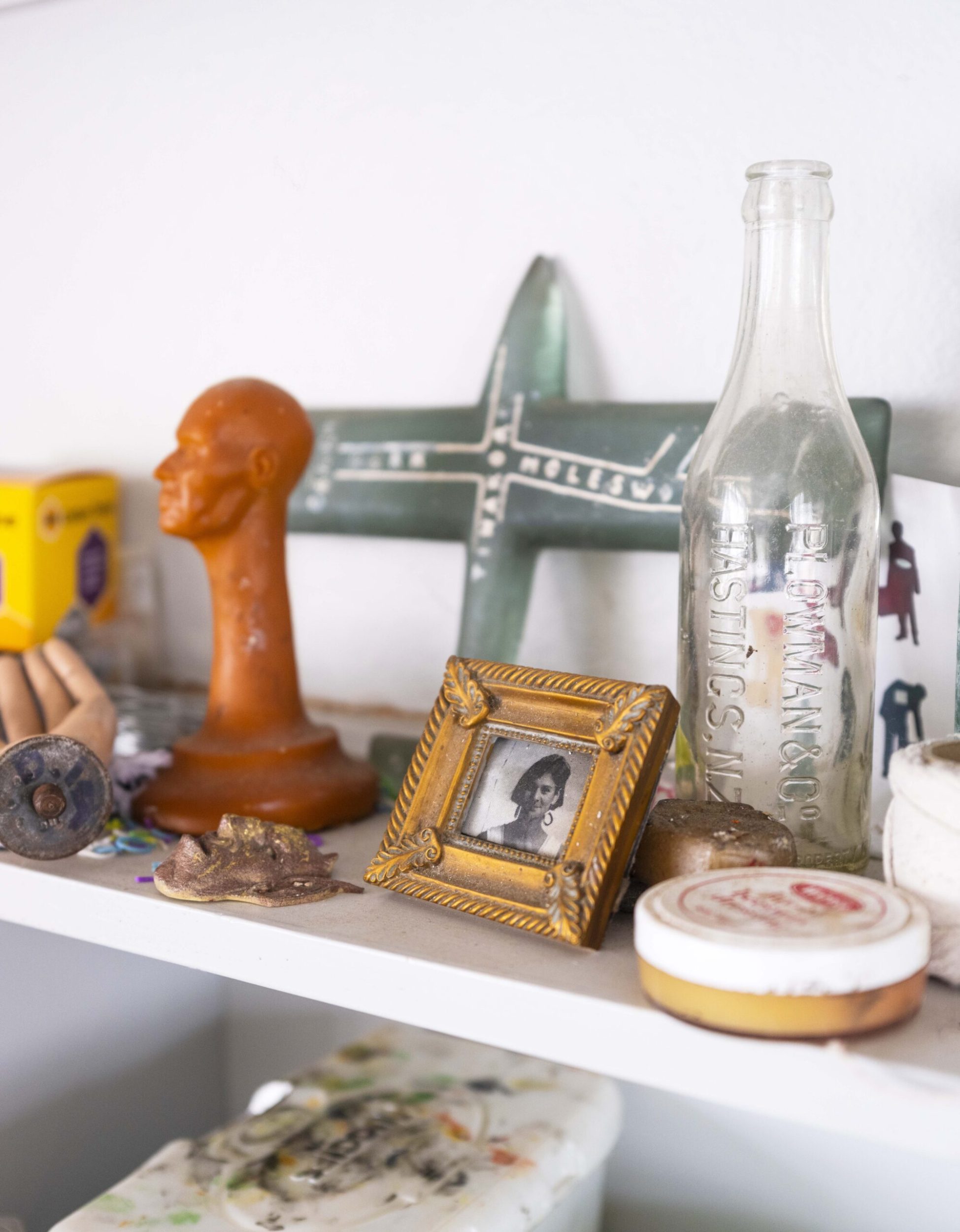 A shelf with various objects and photo frame