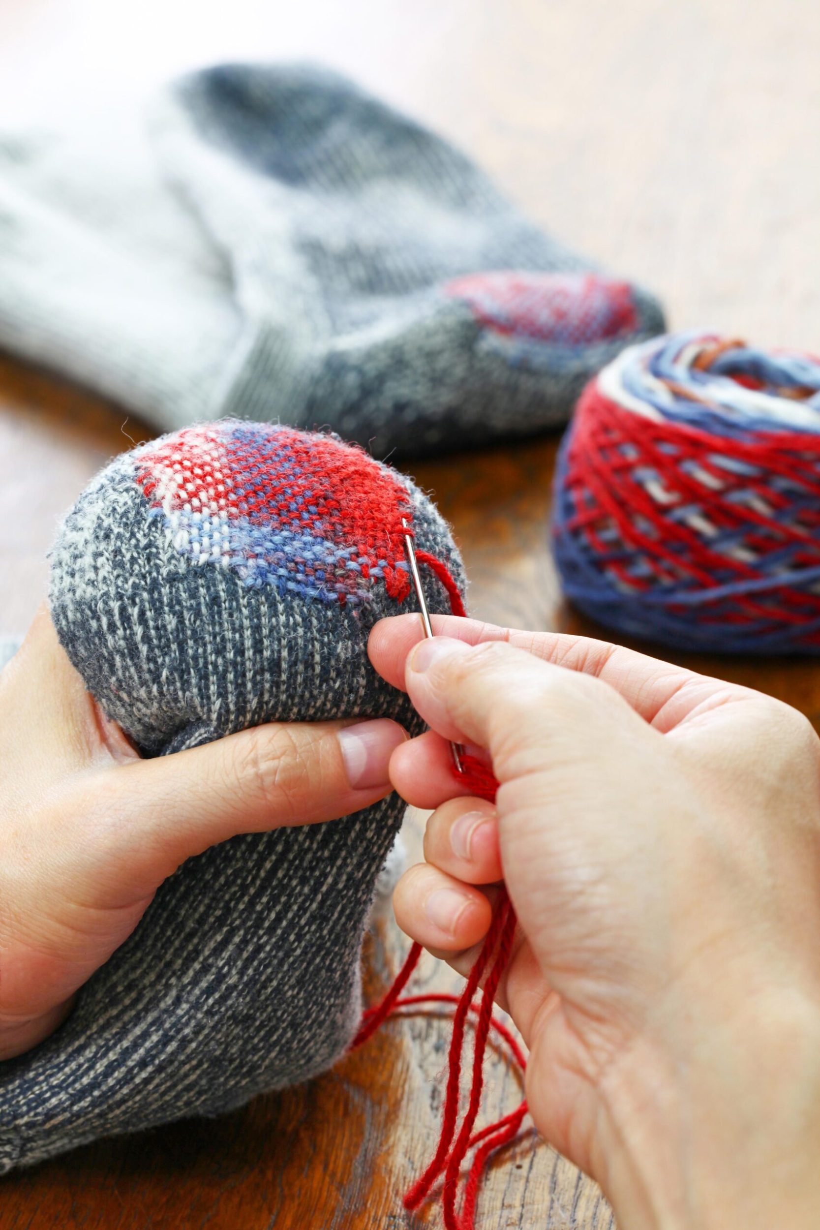 Hands darling blue socks with red thread