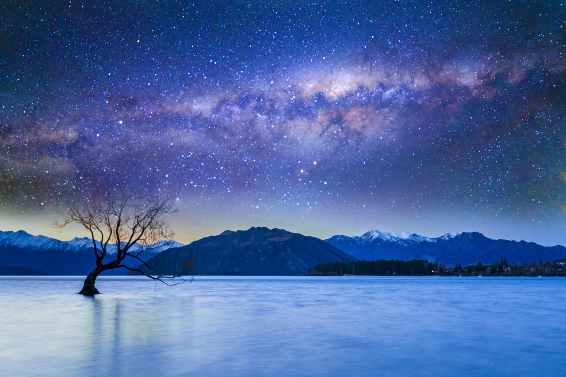 Lake Wanaka at night with starry skies