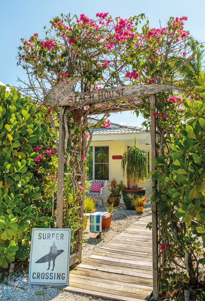 Crossing with pink flowers and wooden path