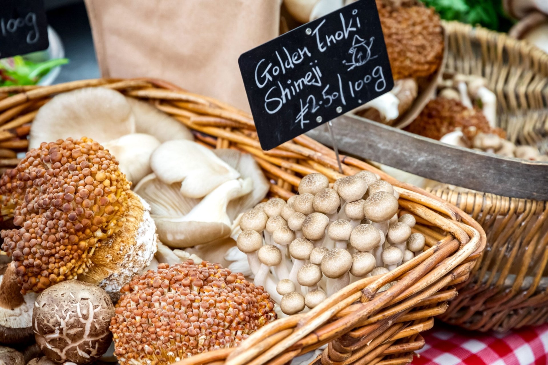 Assorted mushrooms for sale in wicker baskets