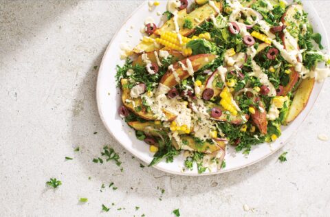 Potato wedges sweetcorn and cos lettuce salad in Ceasar dressing