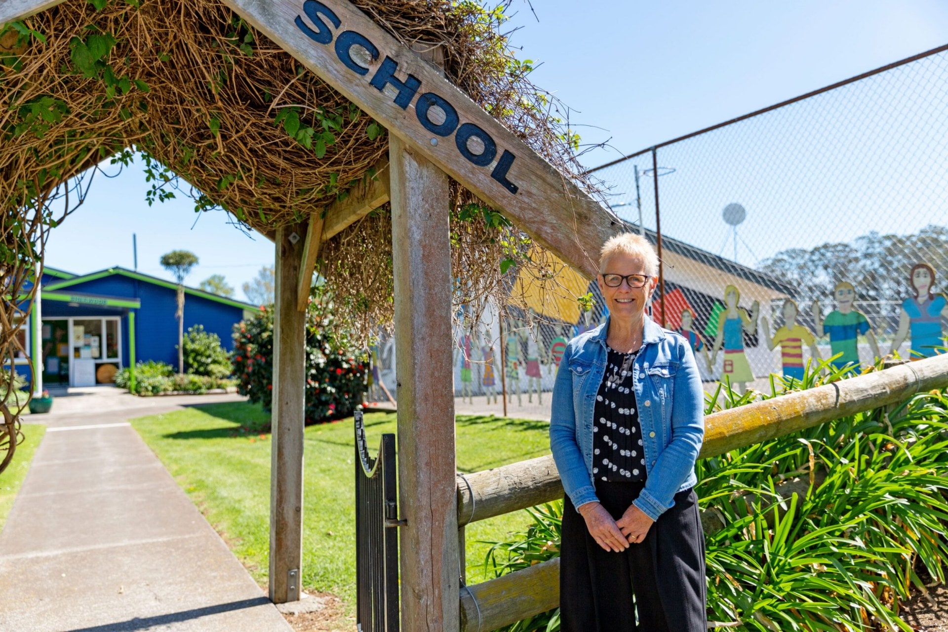 Christine Morrison standing in front of her school