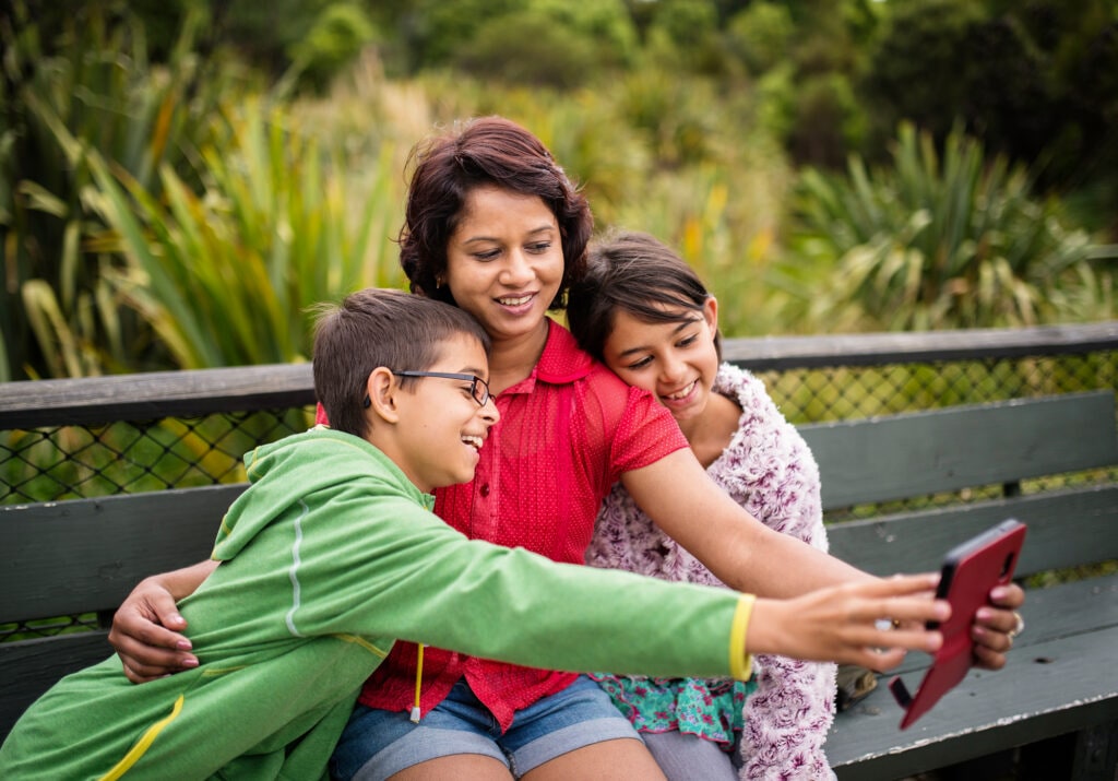 Mother and kids taking selfie on phone