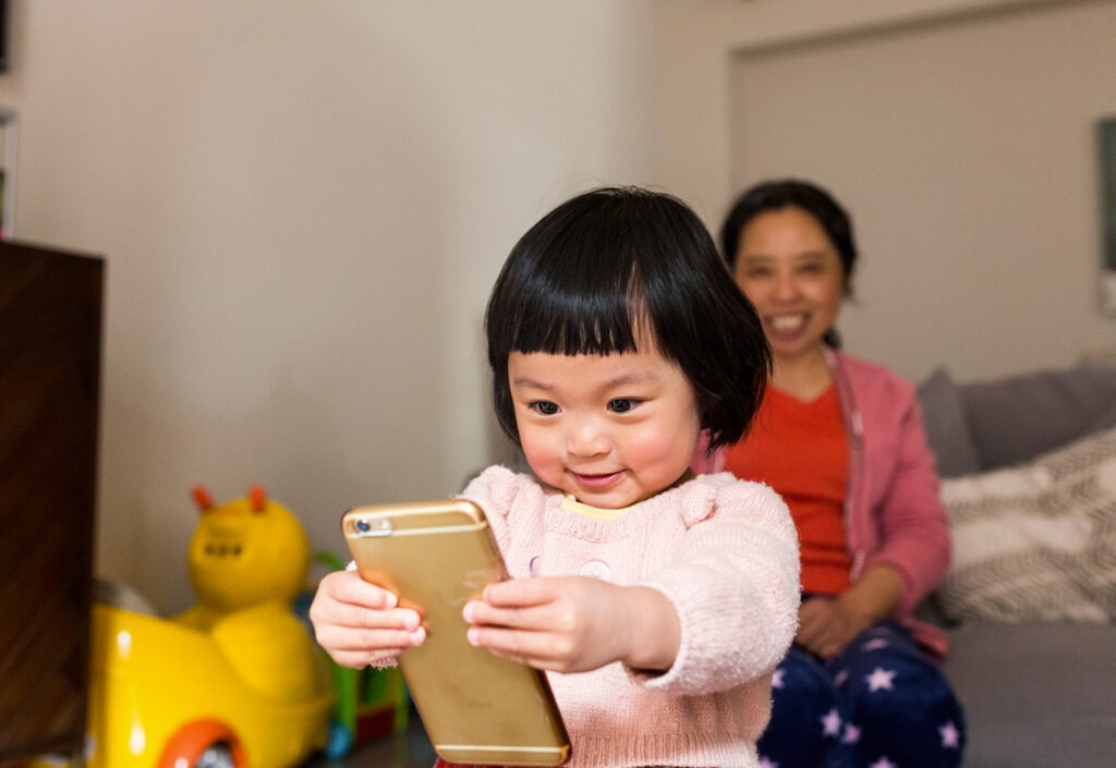 Young girl holding iPhone