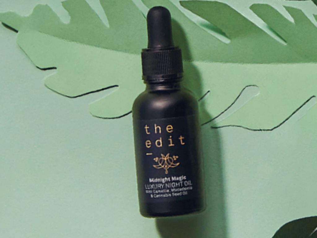 The Edit Midnight Magic Luxury Night Oil on a green background