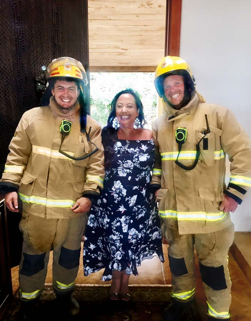 Leah Panapa smiling with two firemen