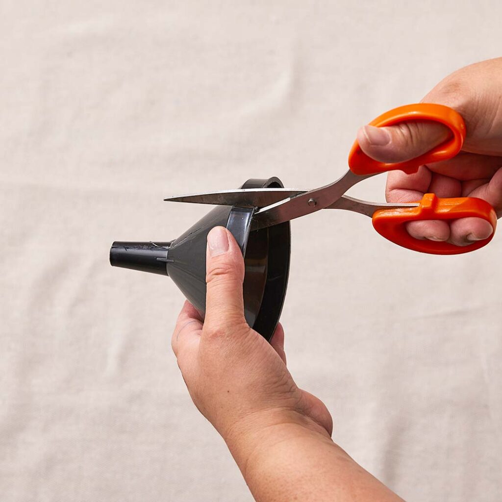 Person using scissors to cut the funnels