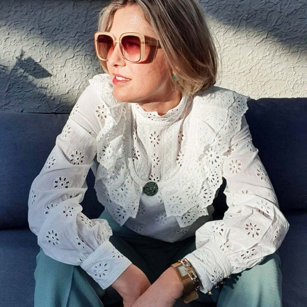 Stephanie King wearing a white blouse and sunglasses