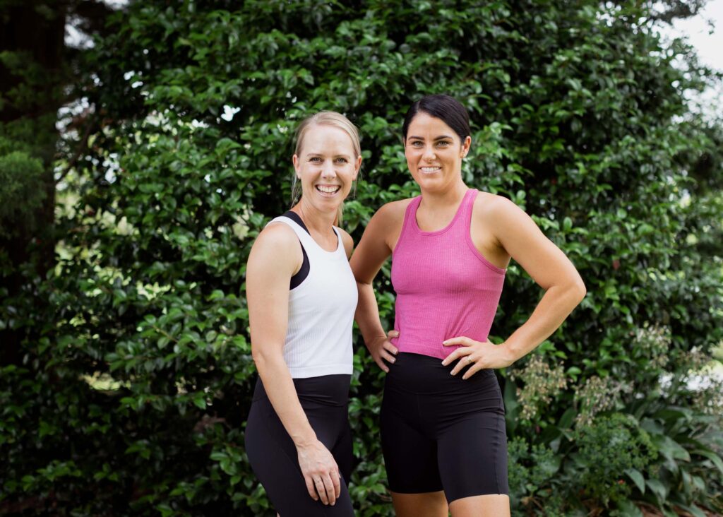 two smiling women in activewear