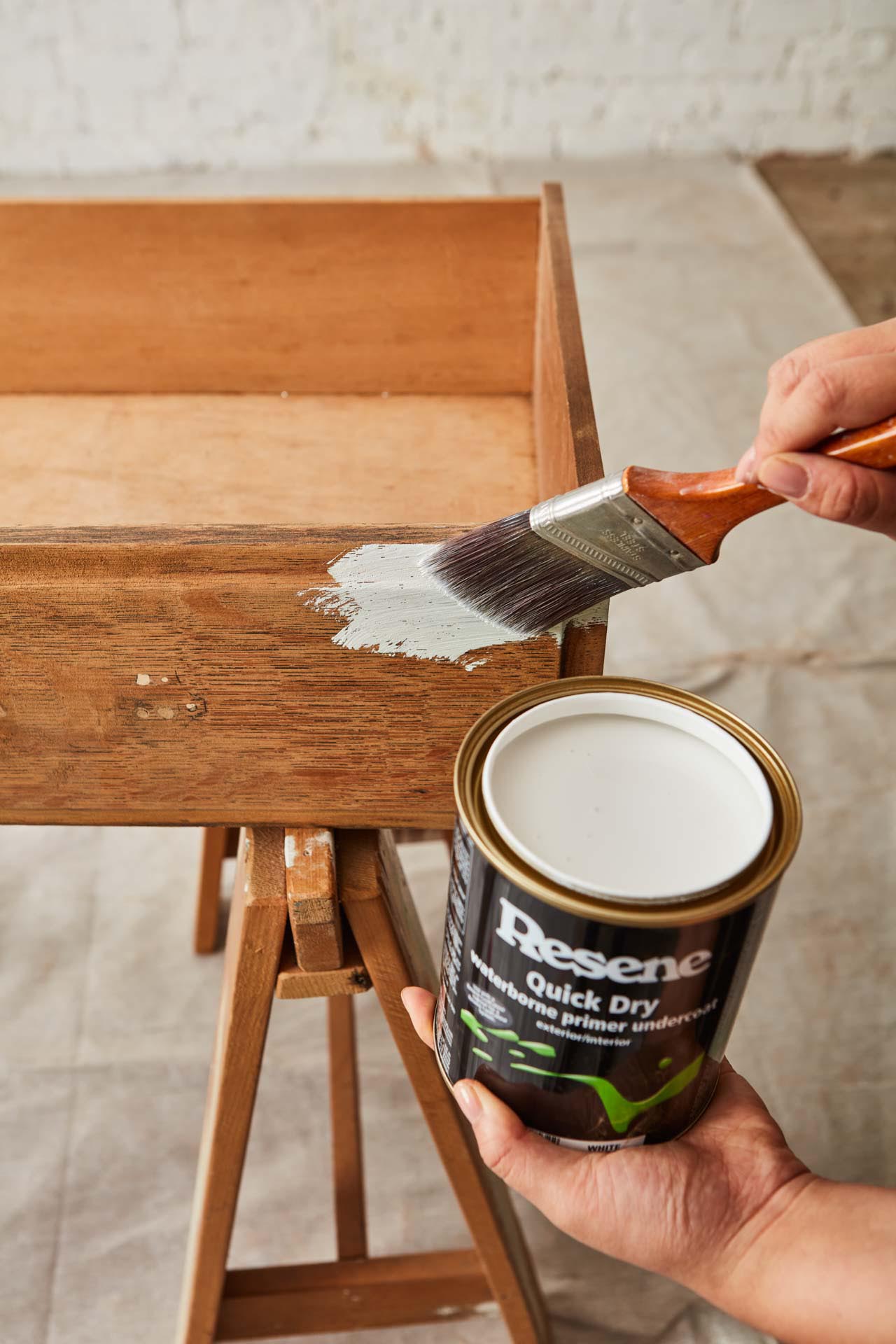 Old drawers being painted in white paint