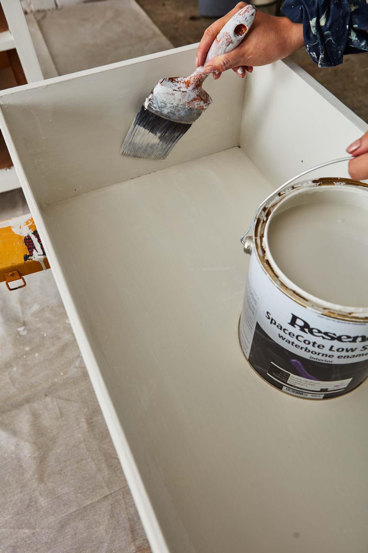 Inside view of old drawers being painted white with Resene SpaceCote Low Sheen