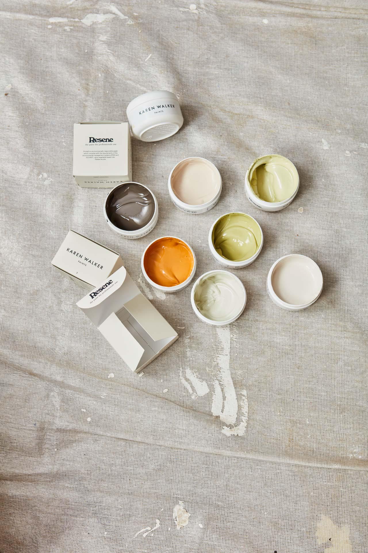 Collection of Karen Walker paint test pots on a drop sheet