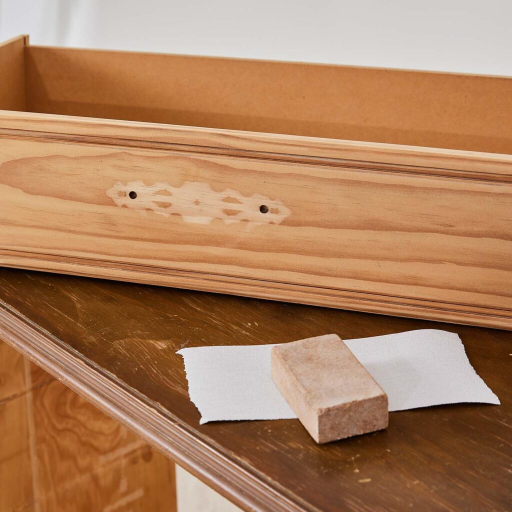 Sandpaper on top of the chest of drawers and next to the drawer