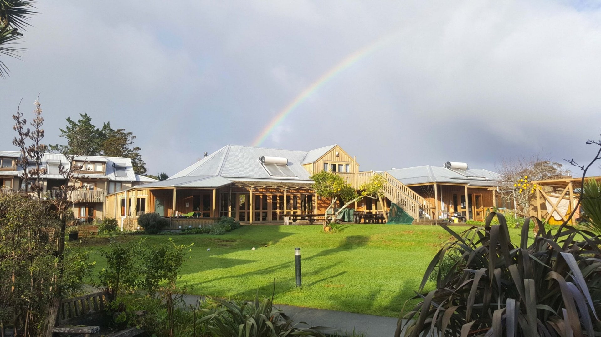 shared housing facilities with a rainbow in the sky