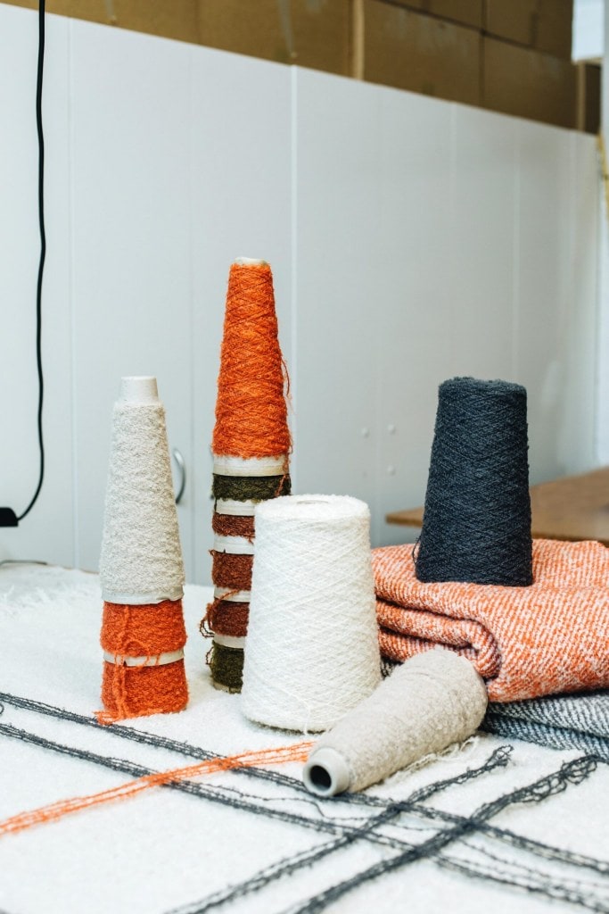 Spools of different coloured mohair stacked on one another