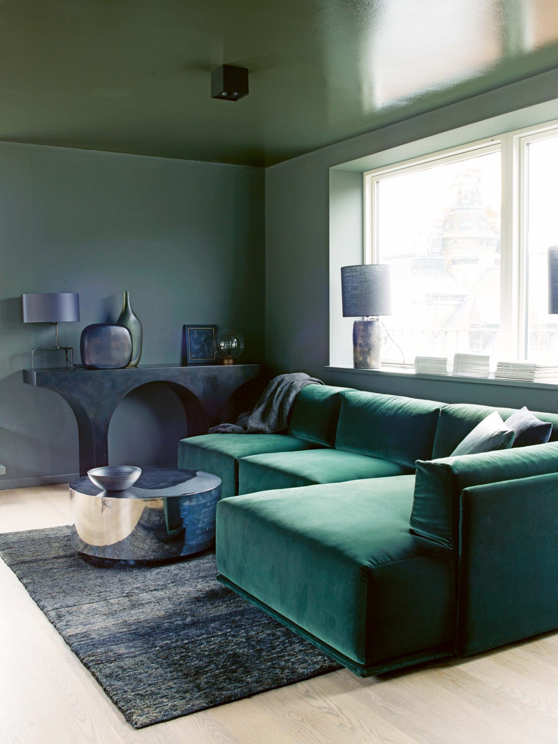 Dark green living room with an emerald green couch