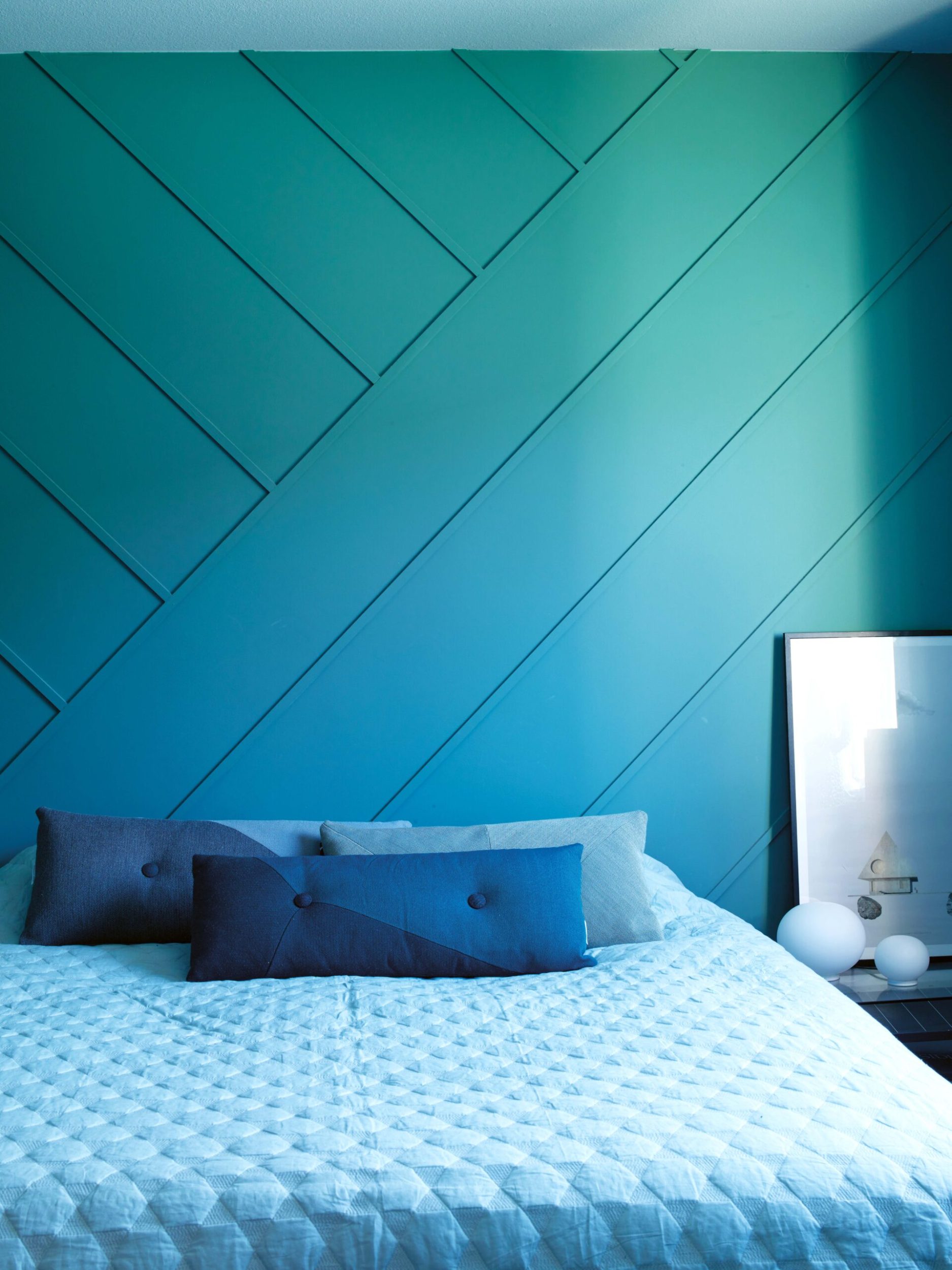 Blue and green bedroom with a blue bedspread