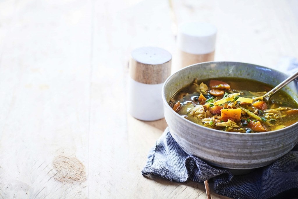 Turmeric and ginger chicken broth recipe in a grey bowl