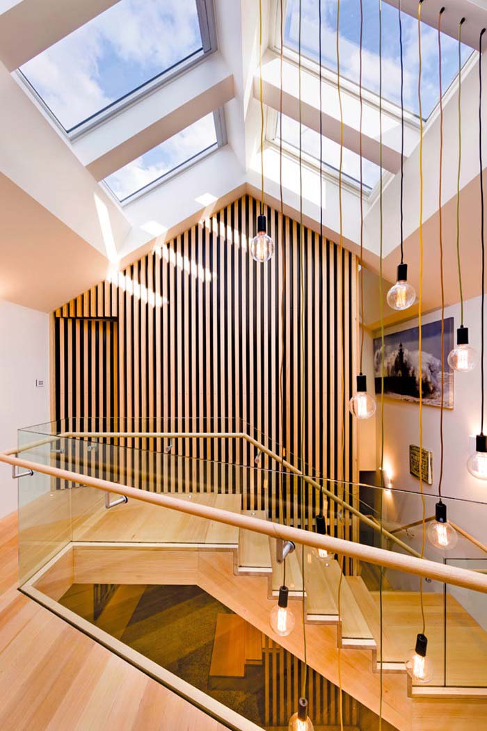 House with wood steps, hanging pendant lights and large skylights