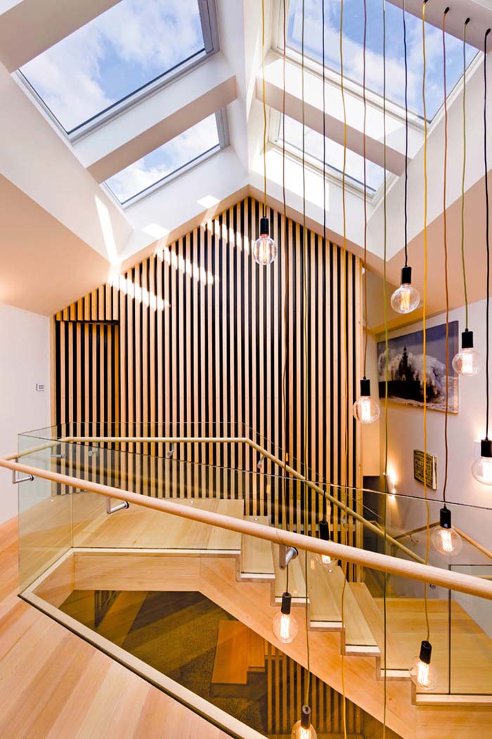 House with wood steps, hanging pendant lights and large skylights 