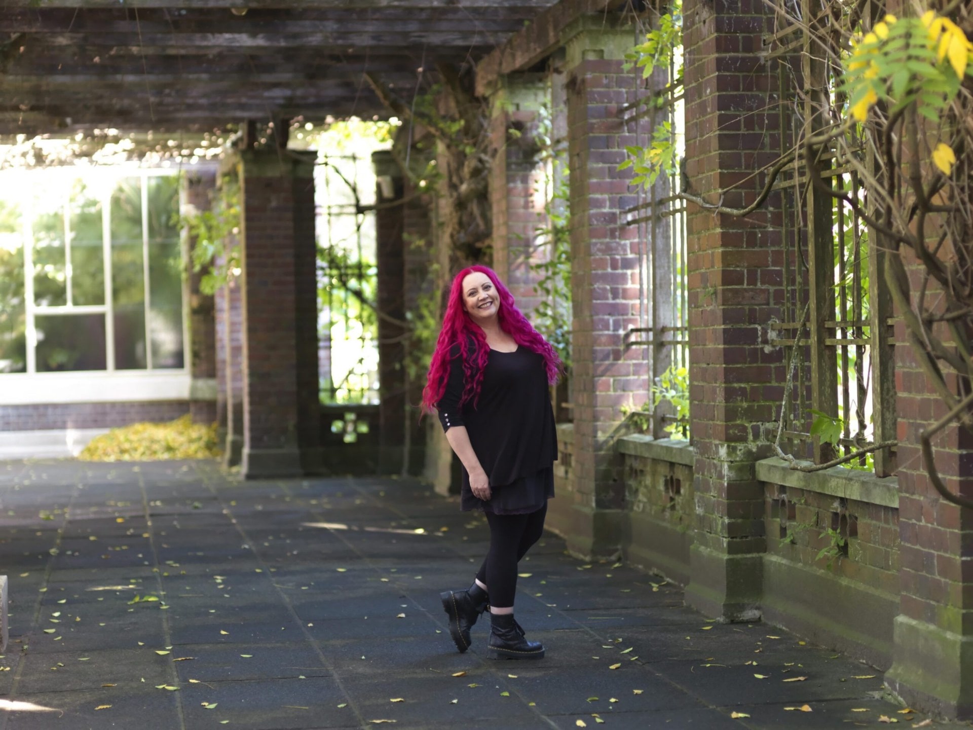 Dr Siouxsie Wiles wearing a black top and pants and Doc Martens 