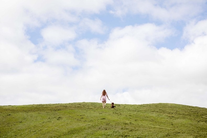 Tiffany Clayton walking up hill with her pet dog