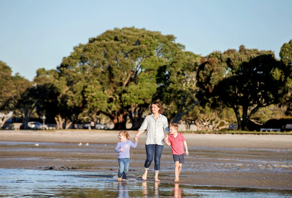 Dr Shari Gallop walking with her kids on an estuary