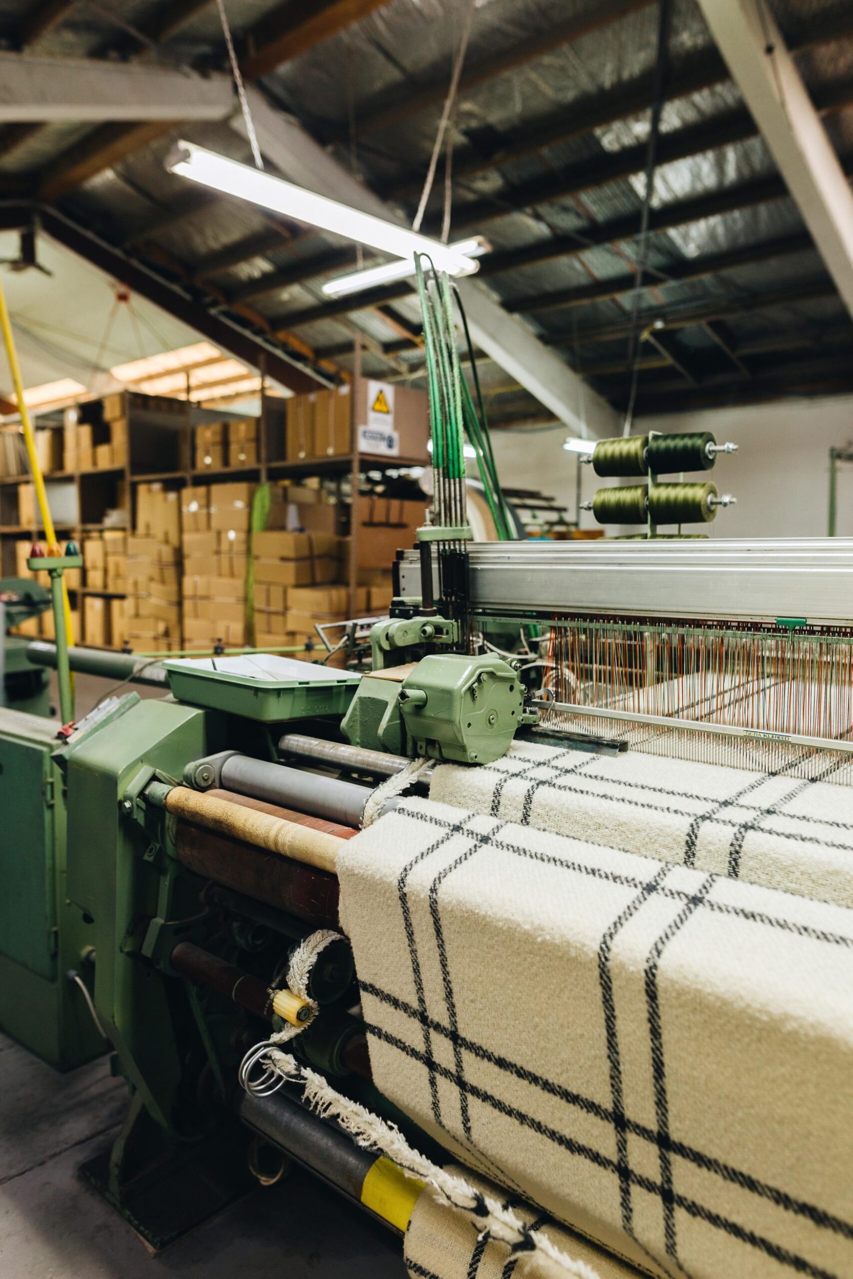 A large black and white striped blanket being woven at the Masterweave factory